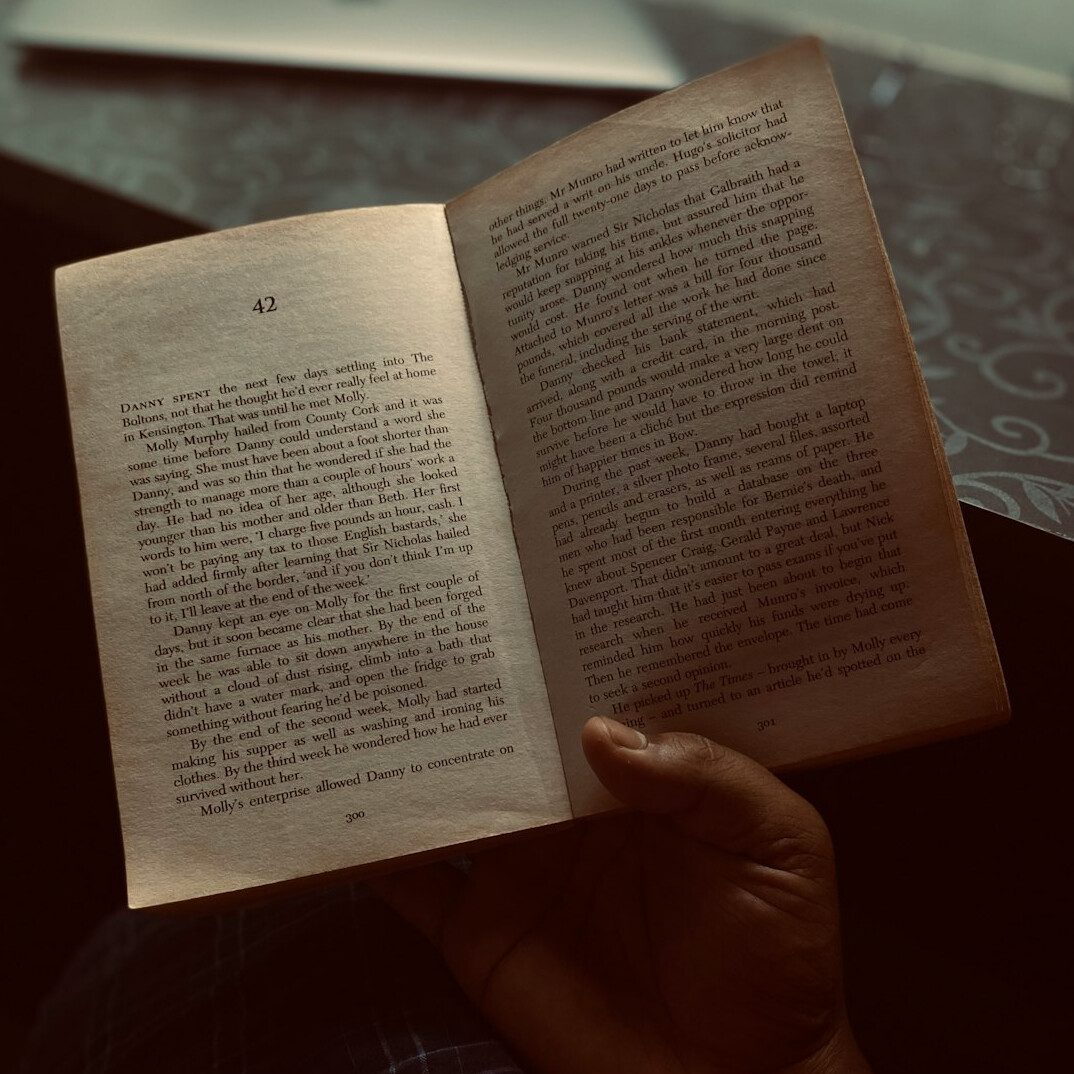 person reading vintage book